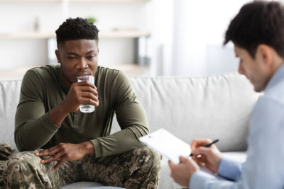 Young african american men in military uniform soldier sitting on couch