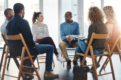 A group therapy session with diverse people sharing their sad problems and stories