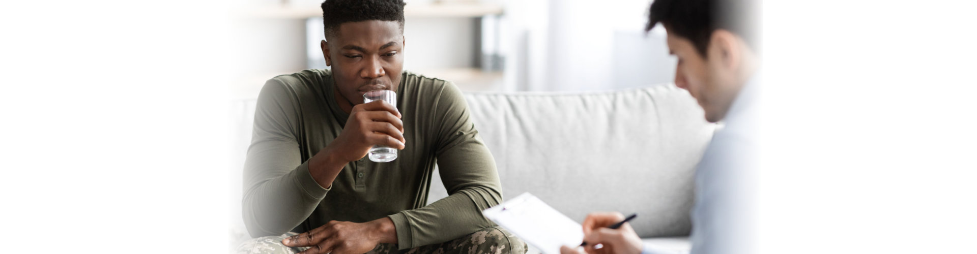 Young african american men in military uniform soldier sitting on couch